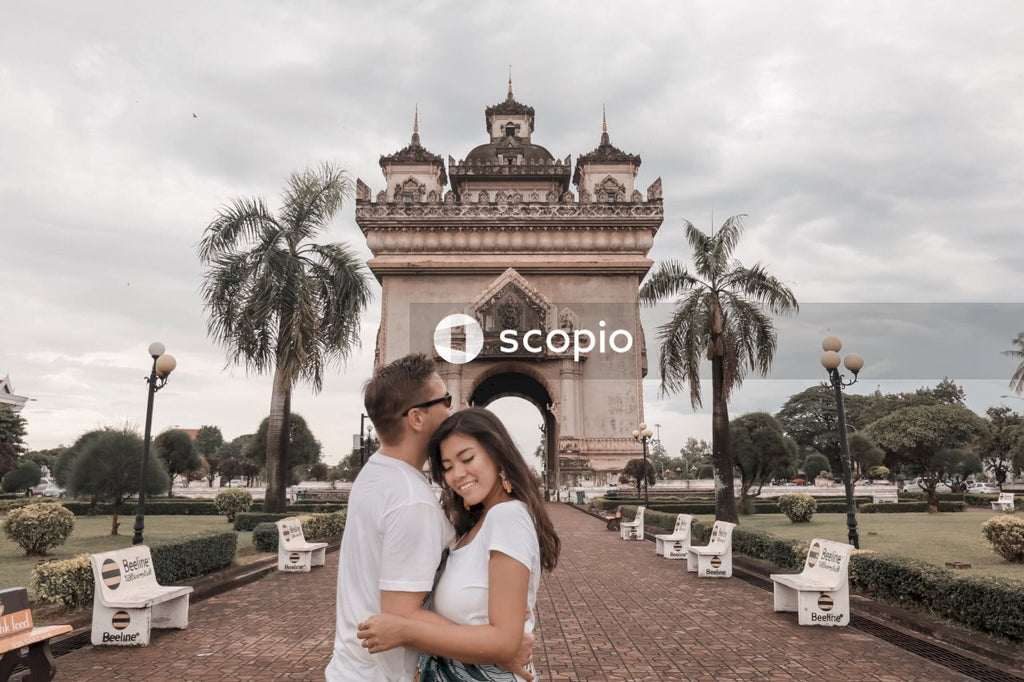 Interracial couple hugging each other near Patuxay Monument in Vientiane, Laos