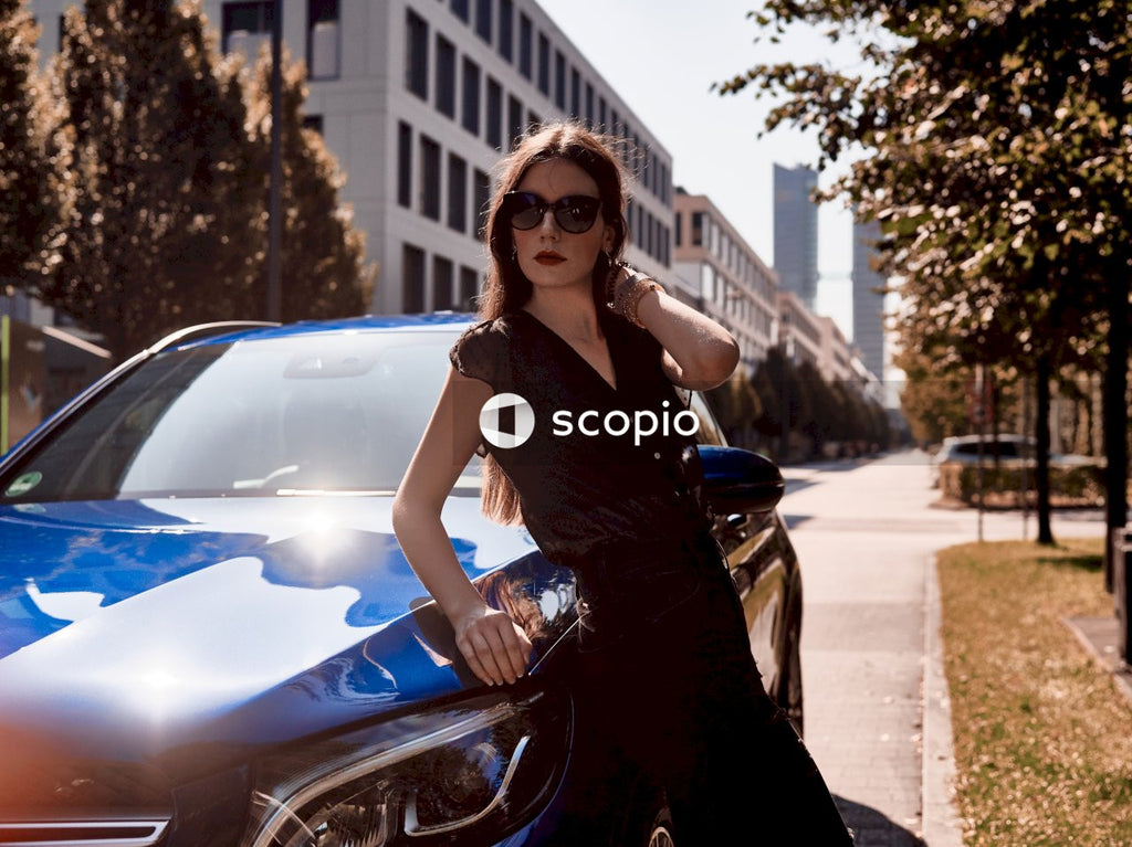 Women Enjoys Sunny Day With Her Blue Car Showing Off Her Style and Status