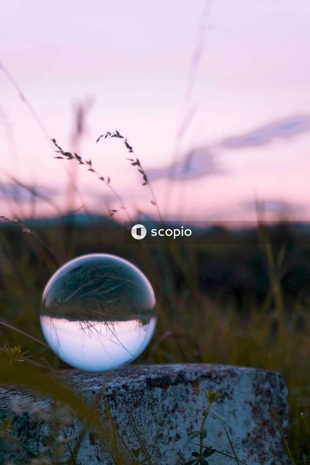 Clear glass ball on gray rock