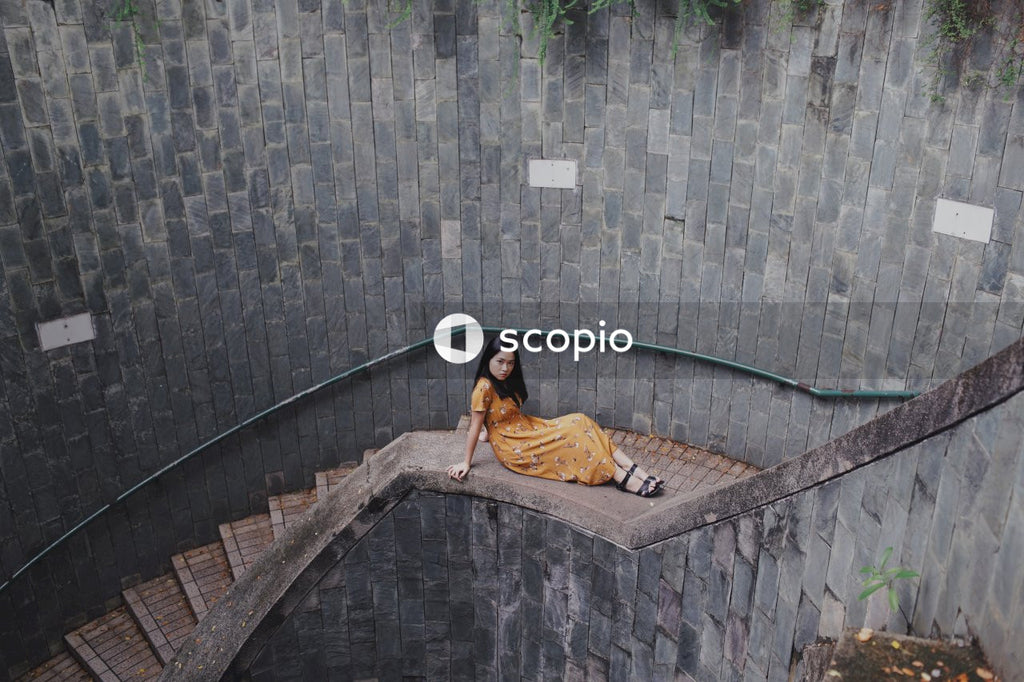 Woman in long orange dress on stairs
