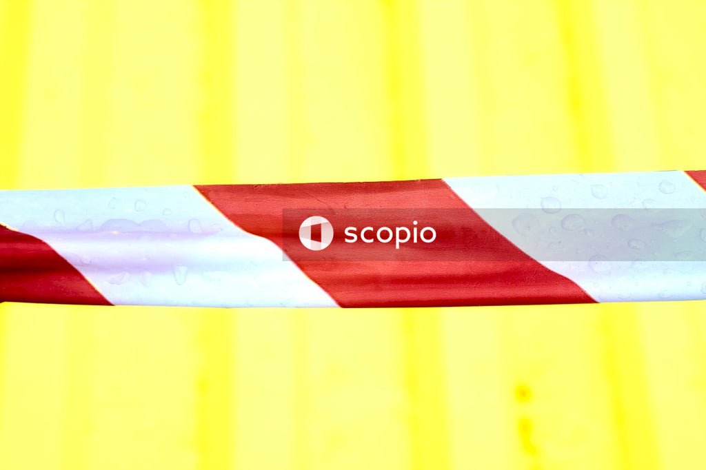 Fencing white red tape on a yellow background