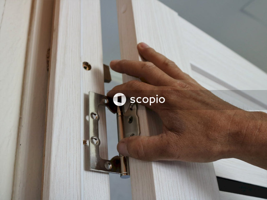 Fingers hold the door canopy at the junction of the frame