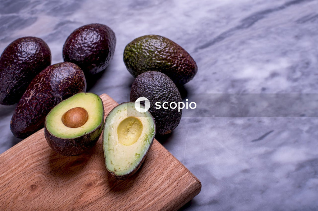 Fresh avocado on a black background. Top view. Free space for your text.