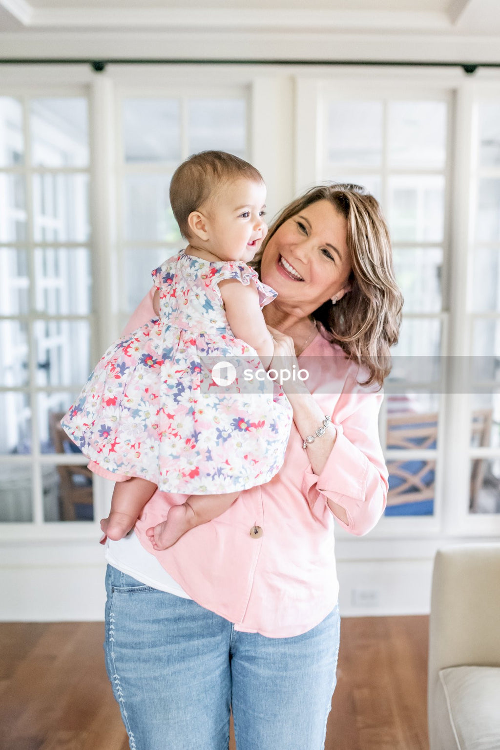 Girl in pink and white floral long sleeve shirt hugging girl in pink and white floral