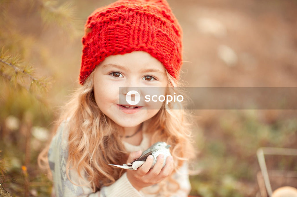 Girl in red knit cap smiling