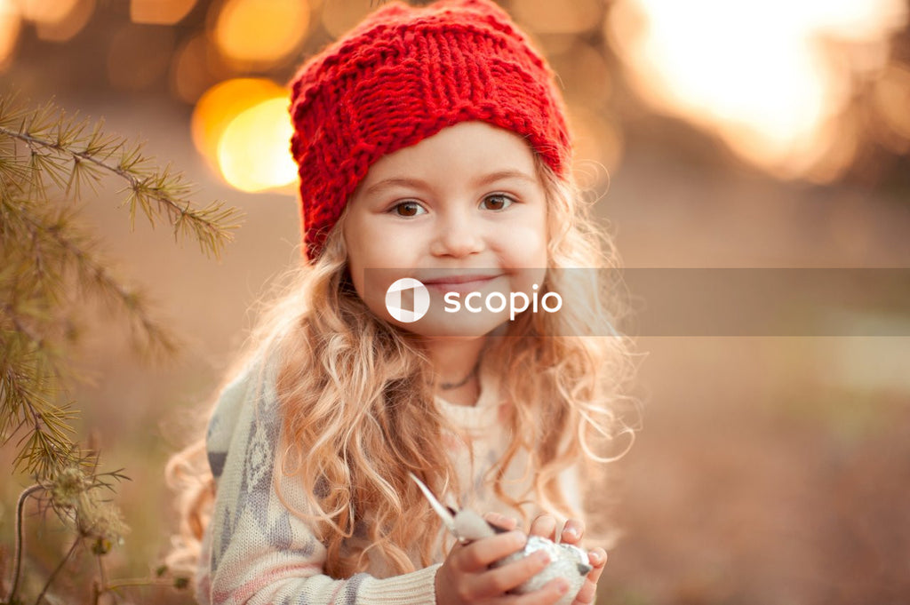 Girl in red knit cap smiling