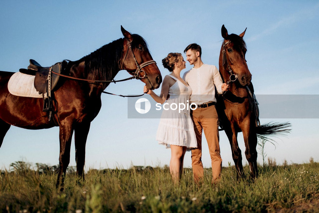 Man and woman beside two horses