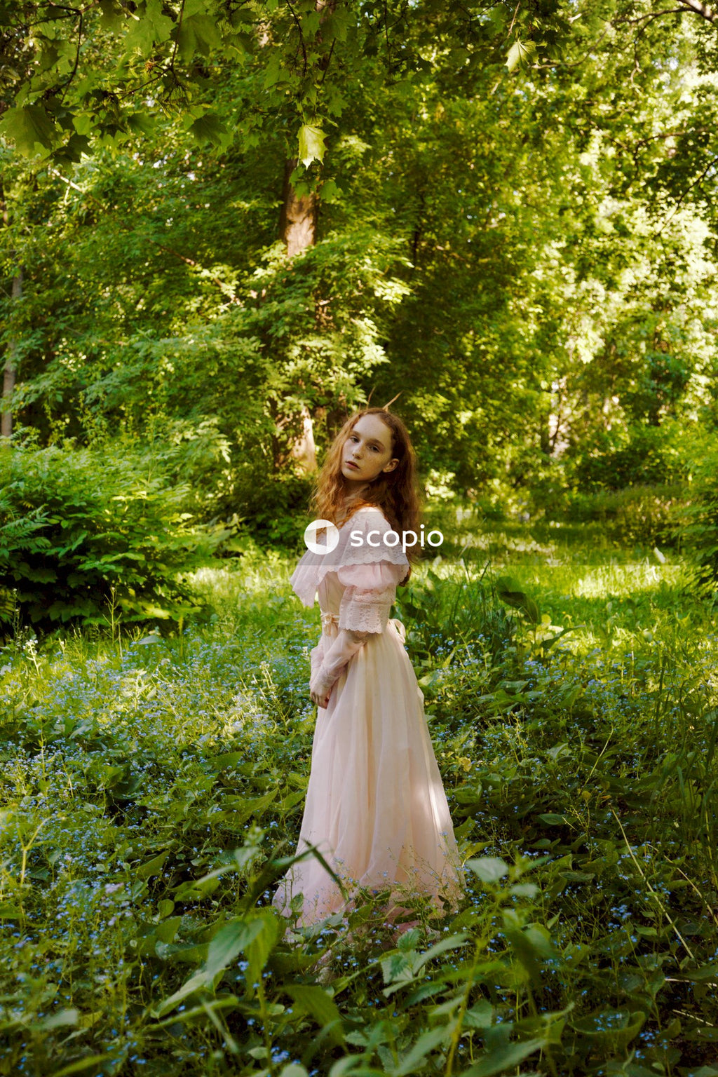 Girl in white dress standing on green grass field