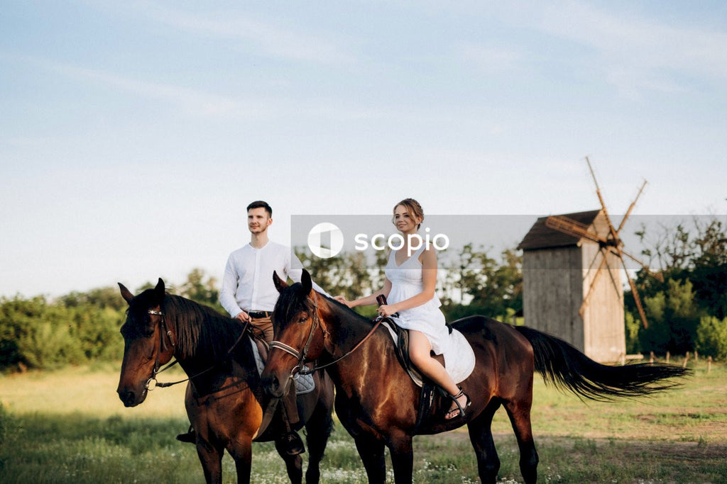 Bride and groom riding horses