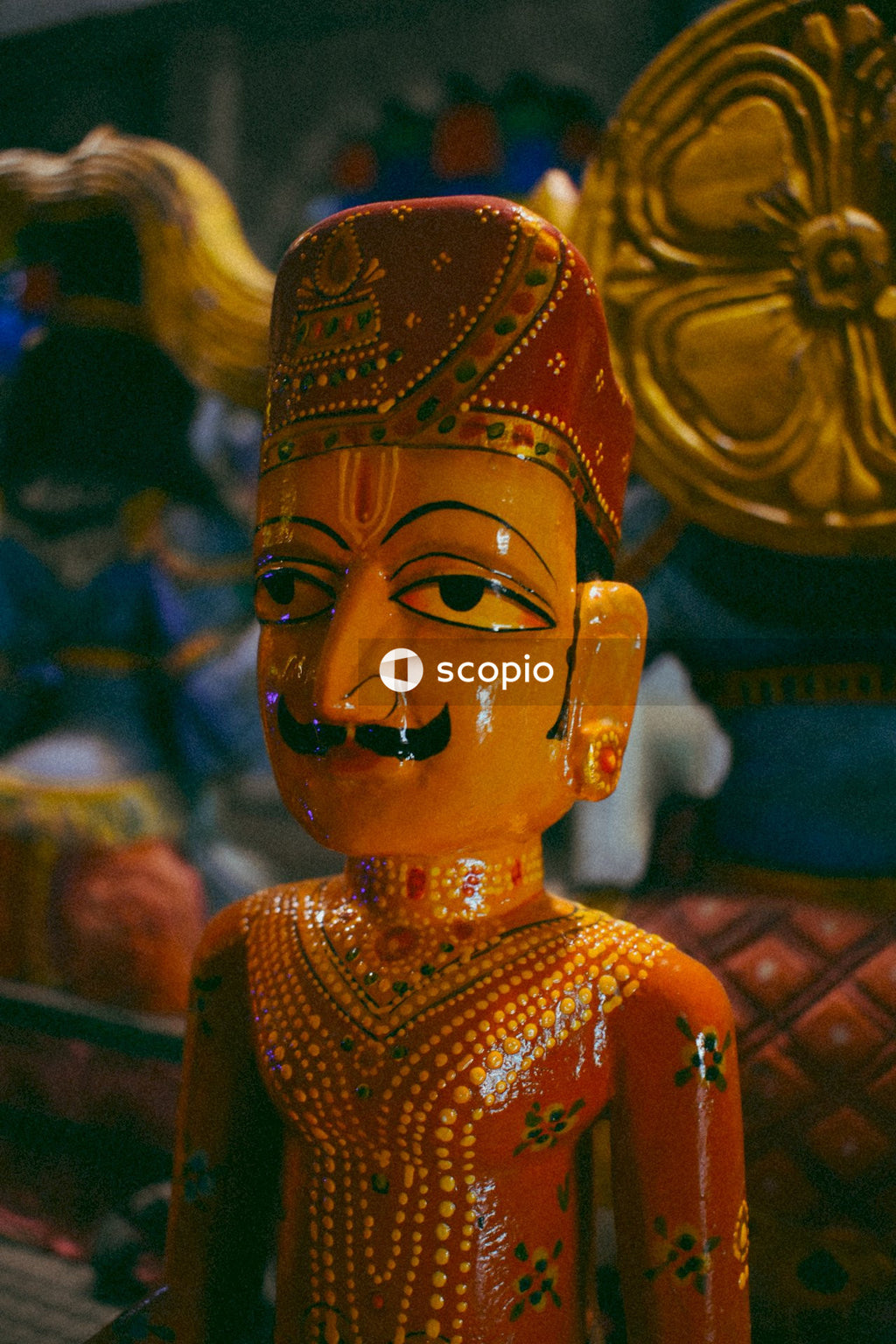 Gold and red hindu deity figurine