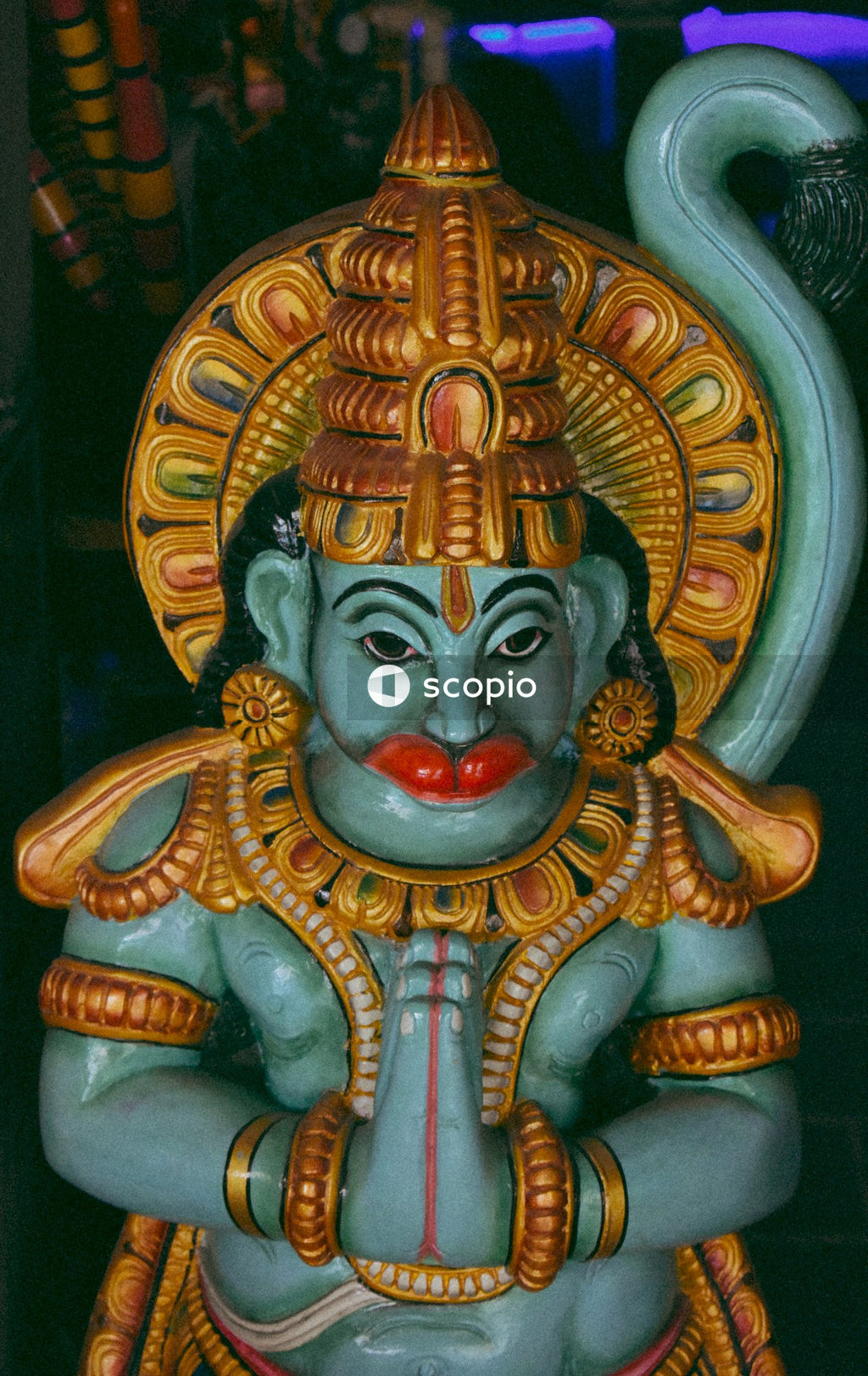Gold and red hindu deity figurine