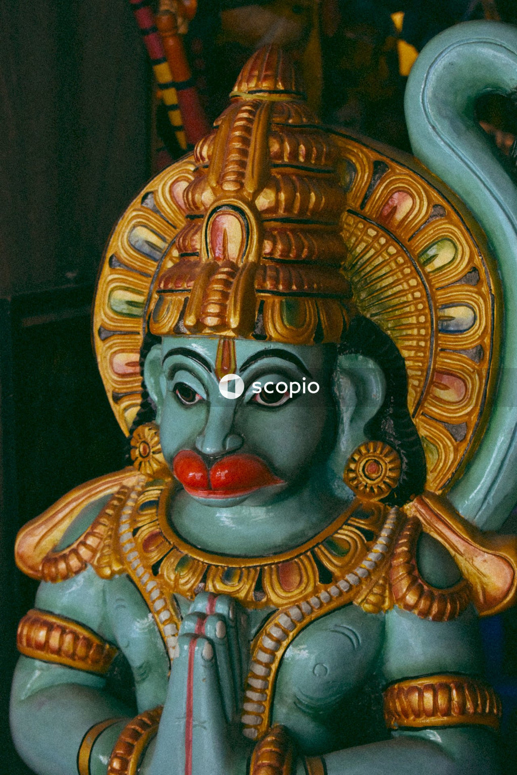 Gold and red hindu deity figurine