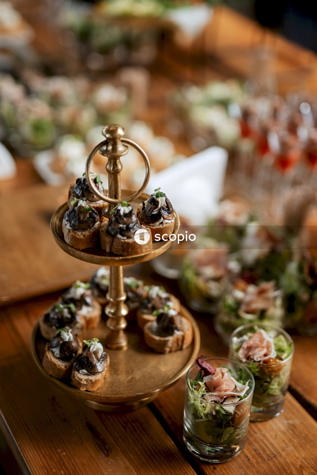 Gold and silver round cake stand on brown wooden table