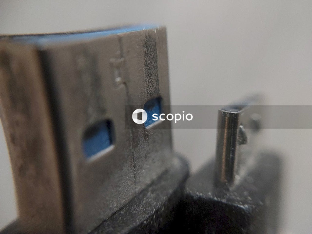 Gray metal tool on white surface
