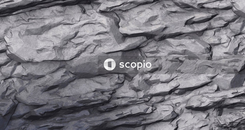 Gray rock formation near blue water