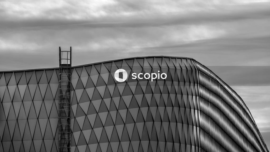 Grayscale photo of building under cloudy sky