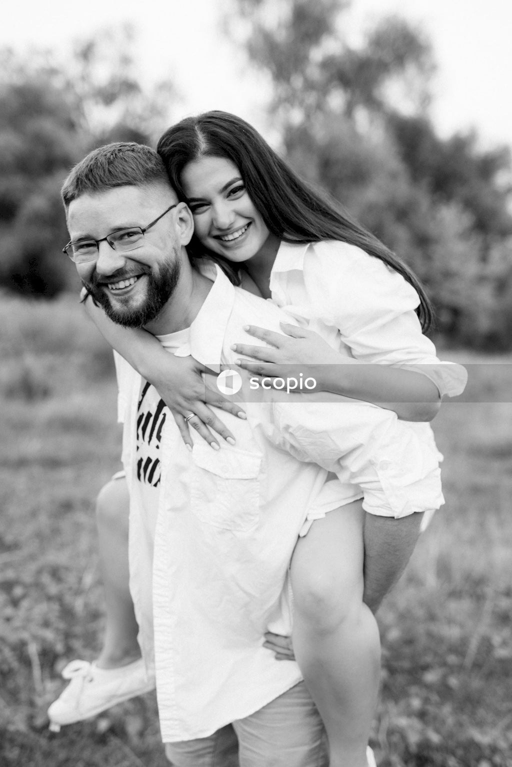 Grayscale photo of couple hugging