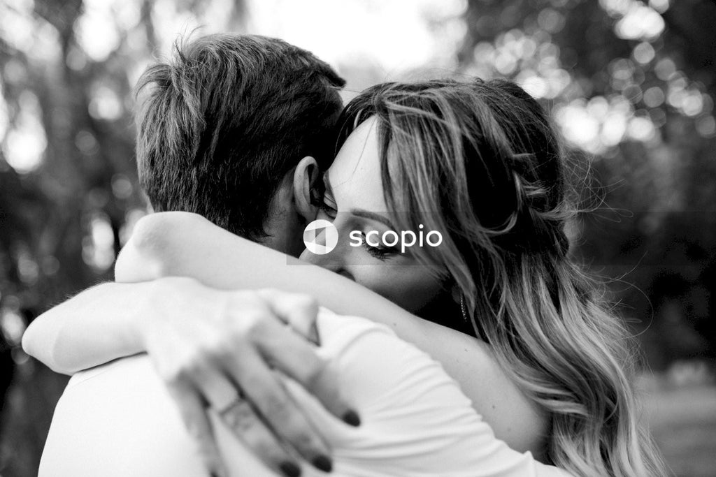 Grayscale photo of couple hugging