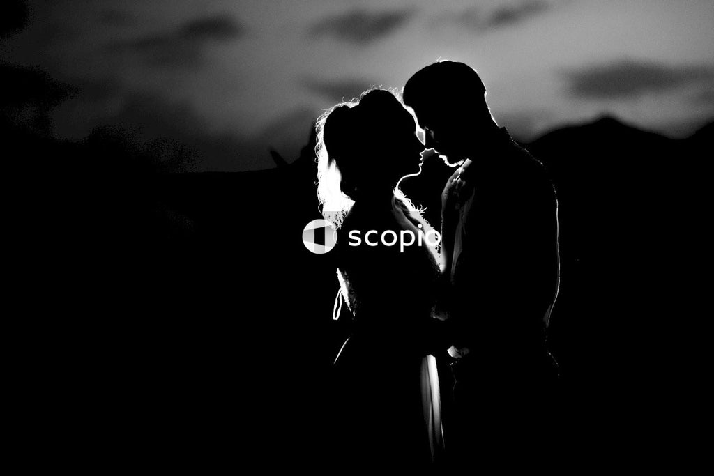 Grayscale photo of couple kissing