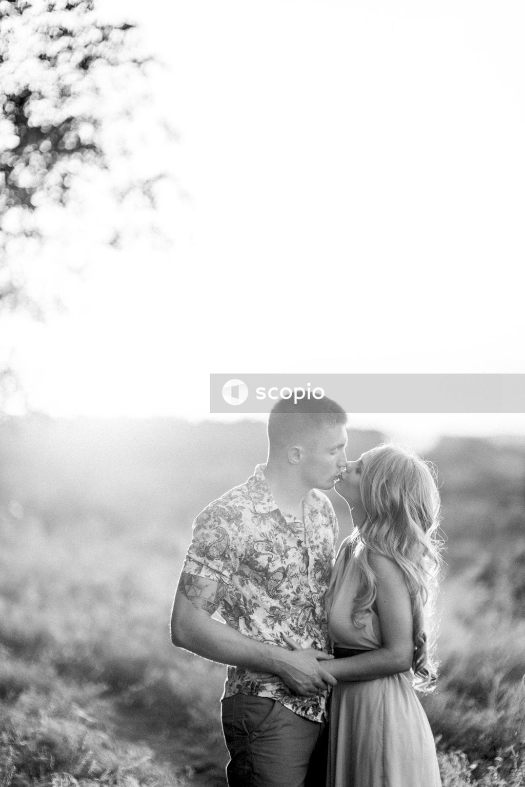 Grayscale photo of couple kissing