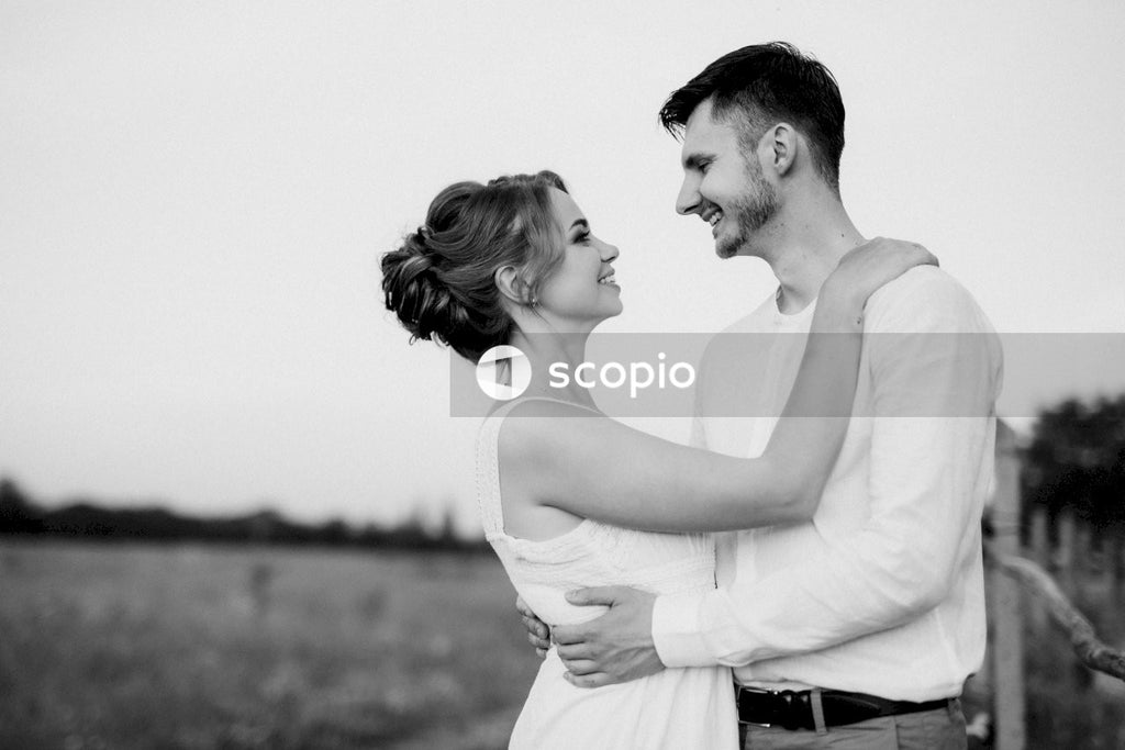 Grayscale photo of couple kissing