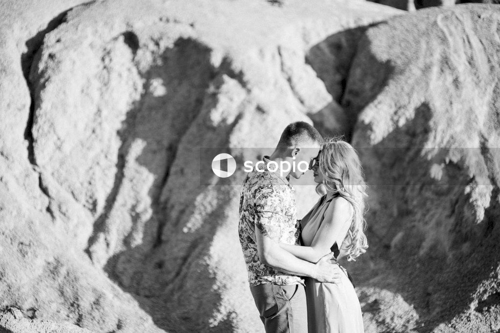 Grayscale photo of couple kissing