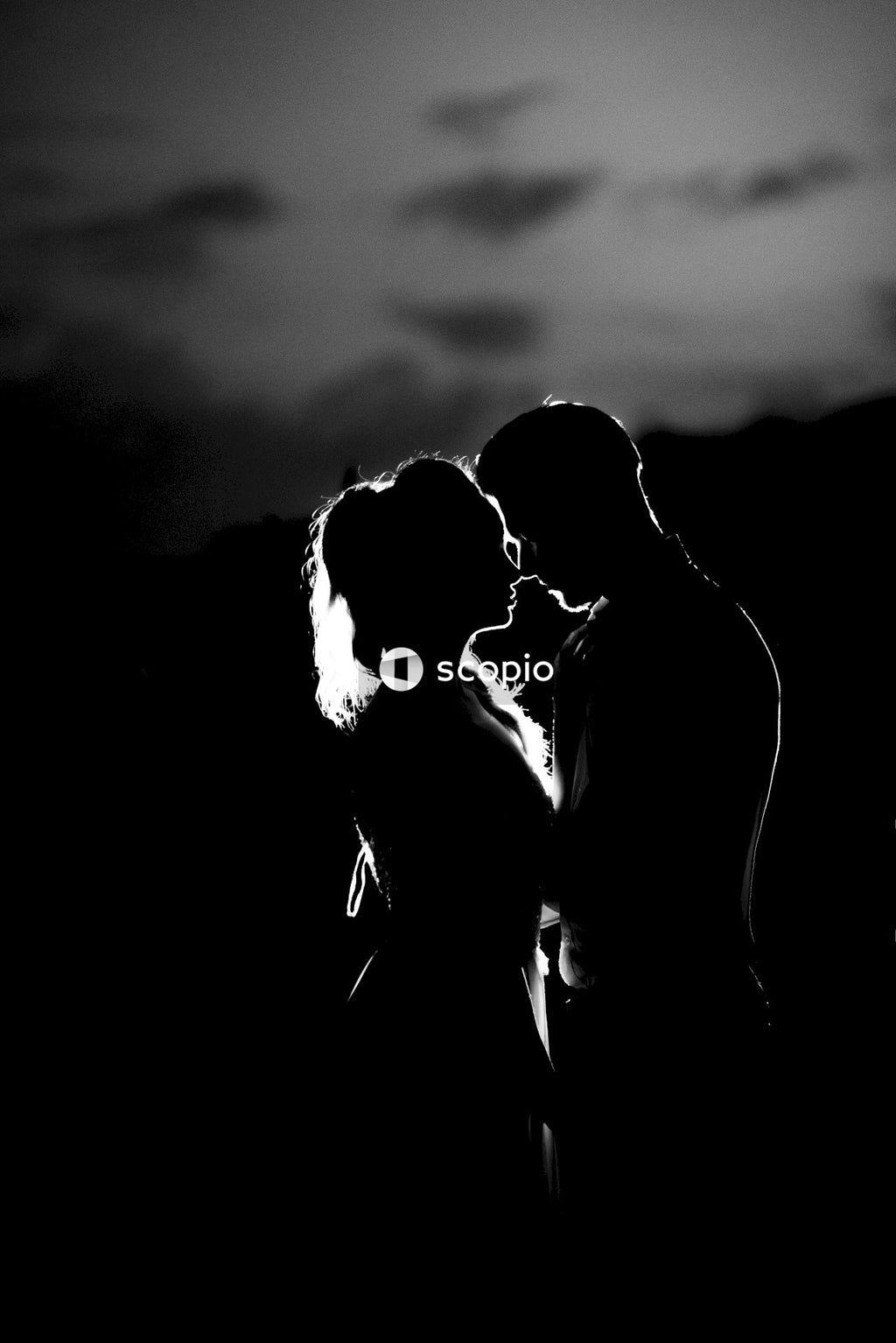 Grayscale photo of couple kissing
