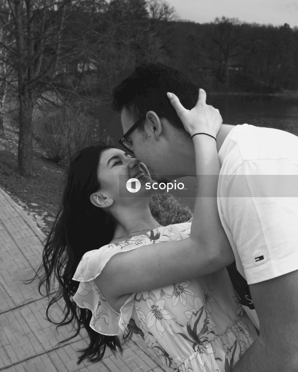 Grayscale photo of couple kissing