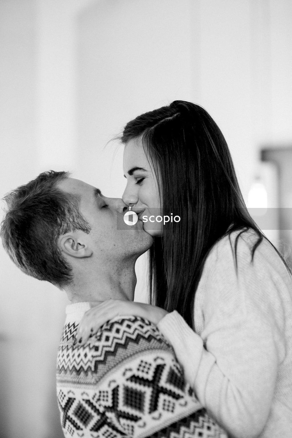 Grayscale photo of couple kissing