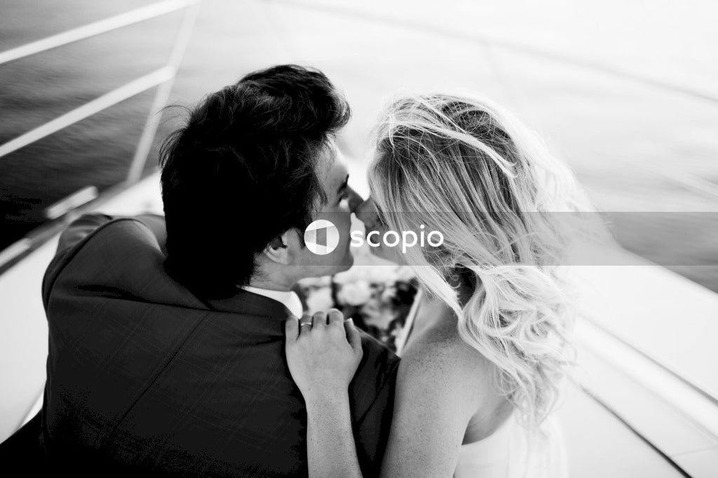 Grayscale photo of couple kissing