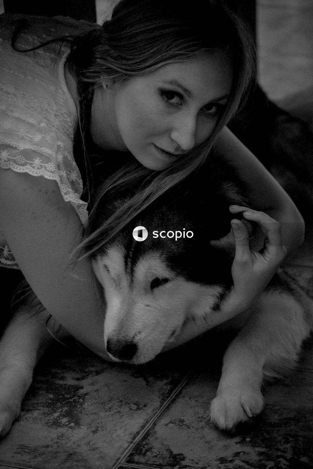 Grayscale photo of girl hugging siberian husky puppy