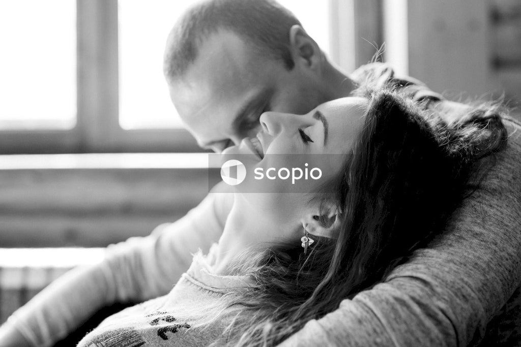 Grayscale photo of man and woman hugging