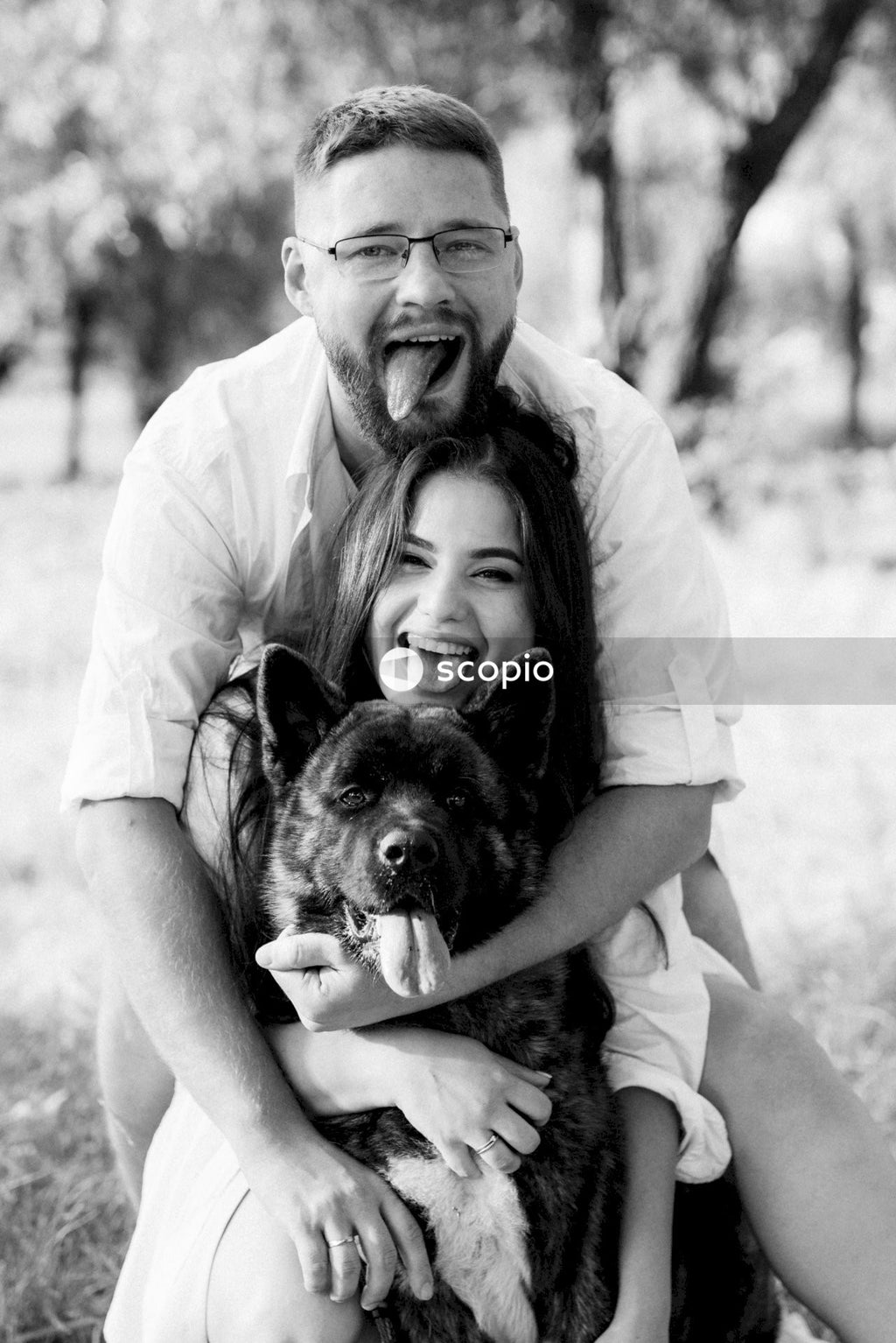 Grayscale photo of man and woman hugging each other