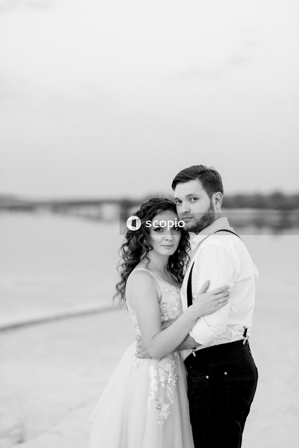 Grayscale photo of man and woman hugging each other
