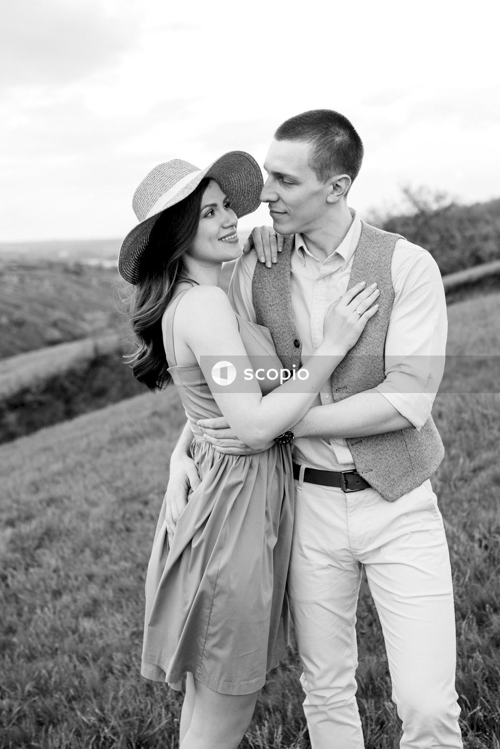 Grayscale photo of man and woman hugging each other