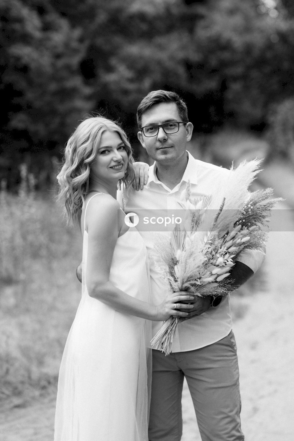 Grayscale photo of man and woman hugging each other
