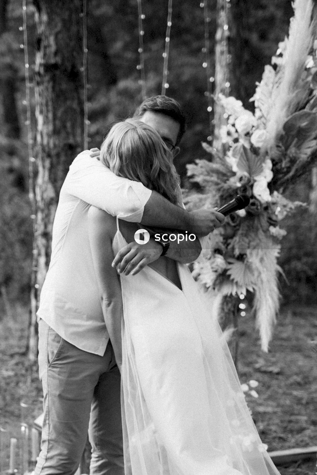 Grayscale photo of man and woman hugging each other