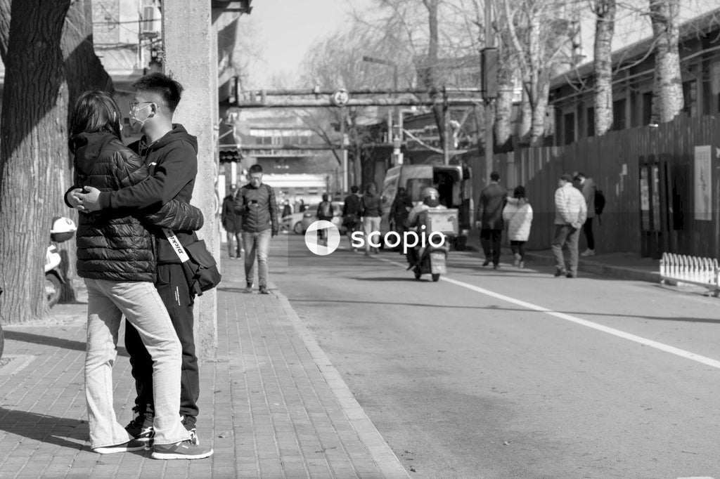 Grayscale photo of couple hugging each other