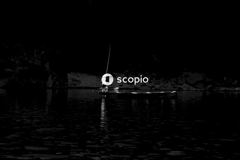 Grayscale photo of person fishing on river