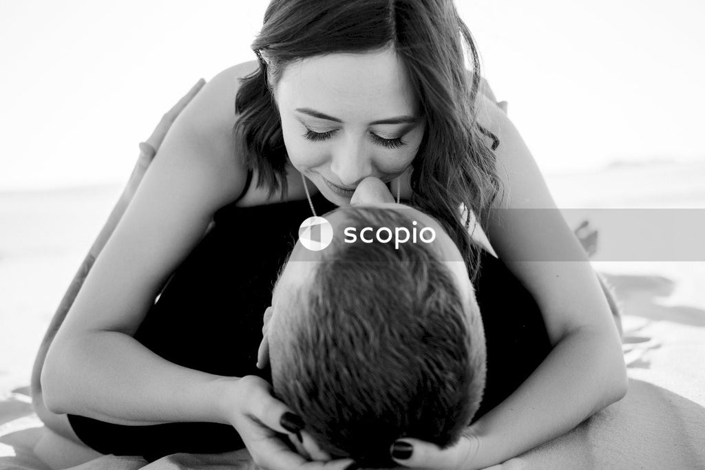 Grayscale photo of woman hugging man