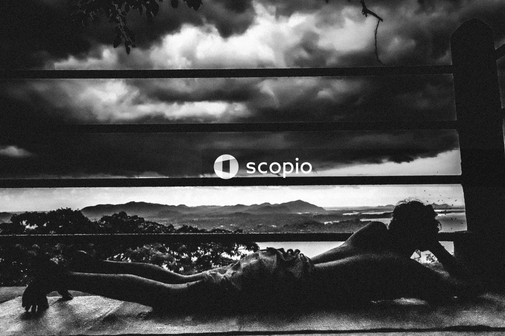Grayscale photo of woman lying on ground