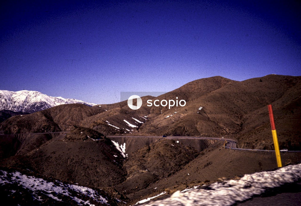 Green and brown mountains under blue sky