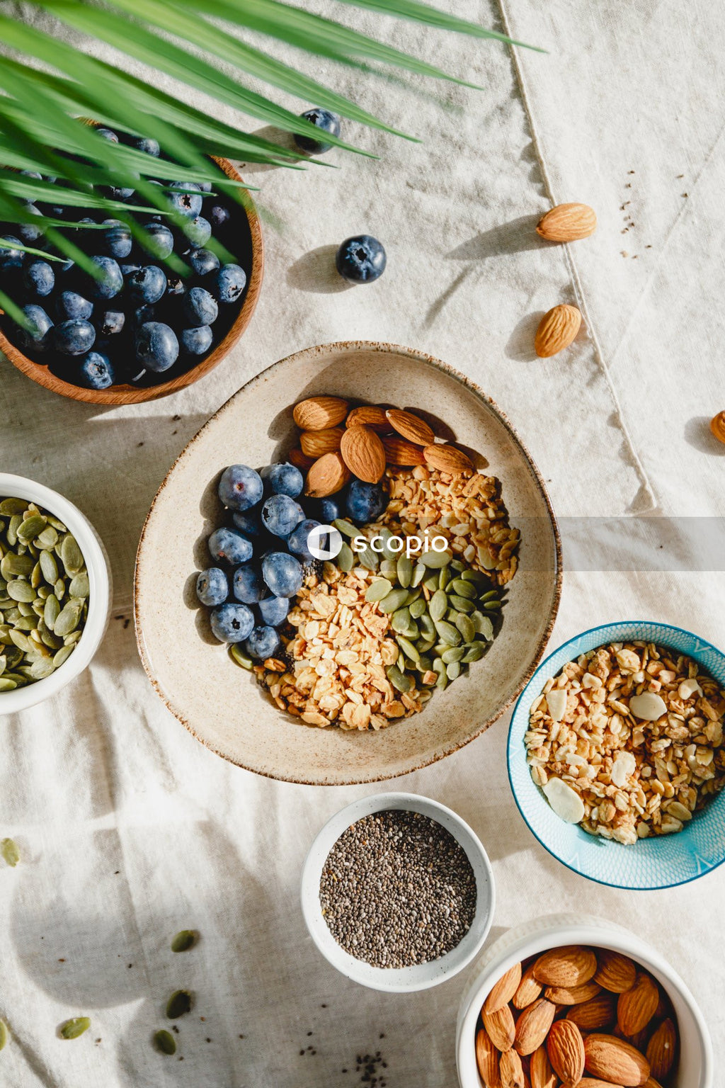 Green and purple grapes on brown wooden bowl