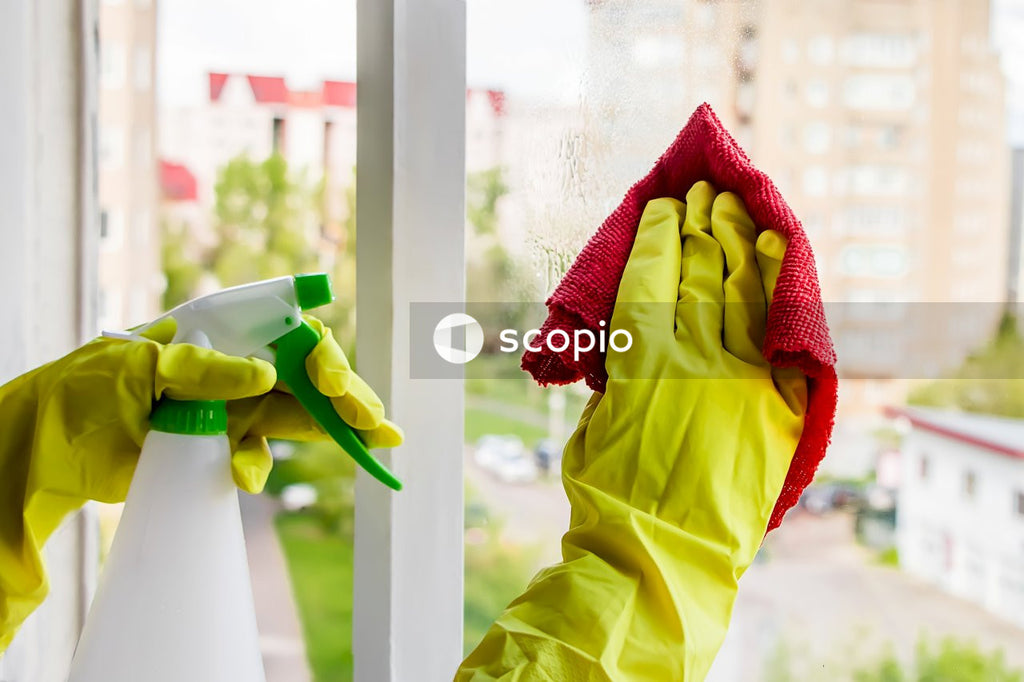 Green and red textile on white wooden fence
