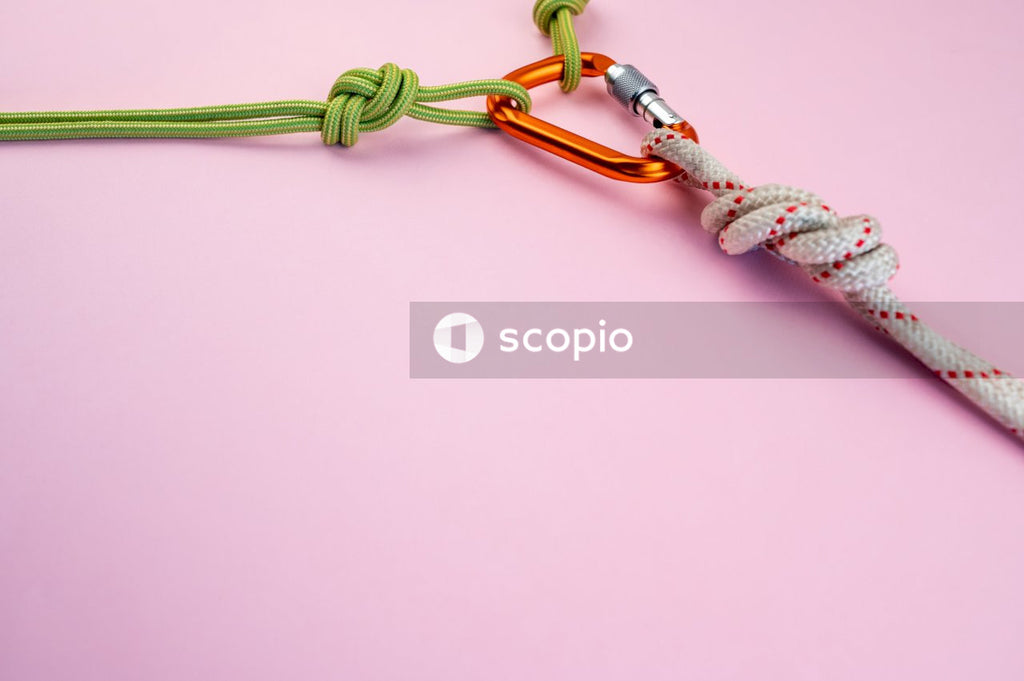 Green and white rope on pink surface