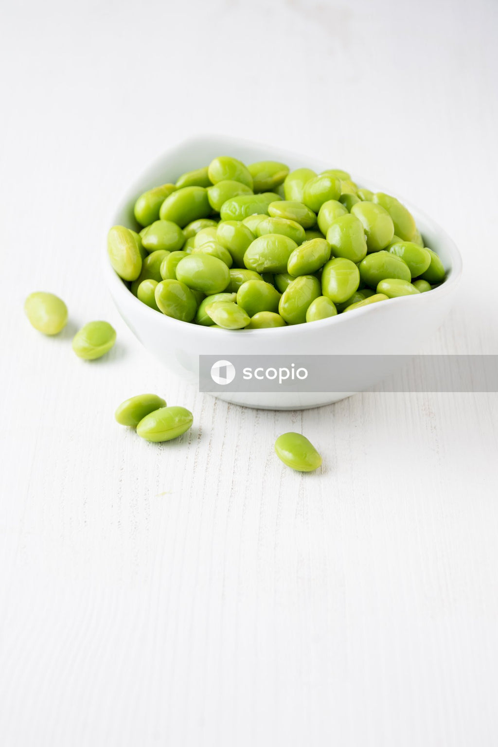 Green fruits in white ceramic bowl