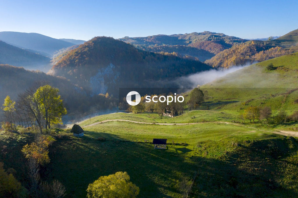Green grass field and green mountains