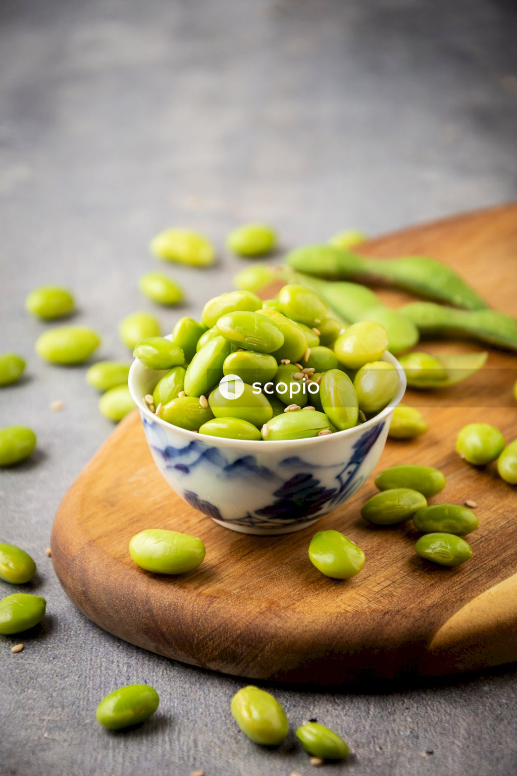 Green peas on white and blue ceramic bowl