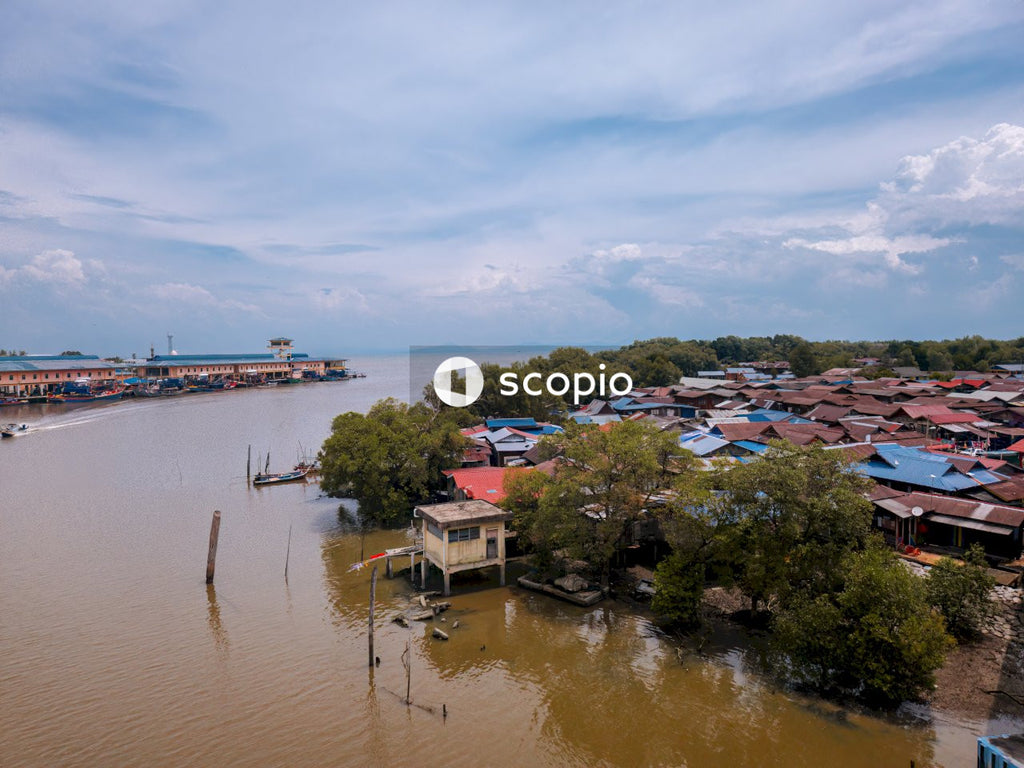 Houses near body of water under blue sky