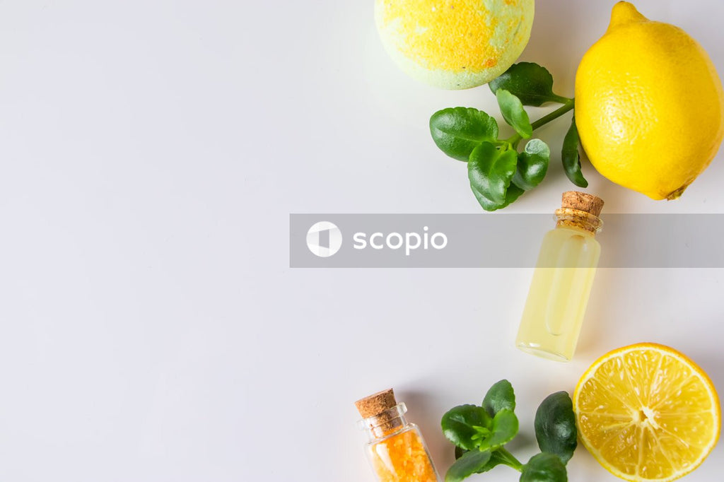 Lemon and green grapes on white table